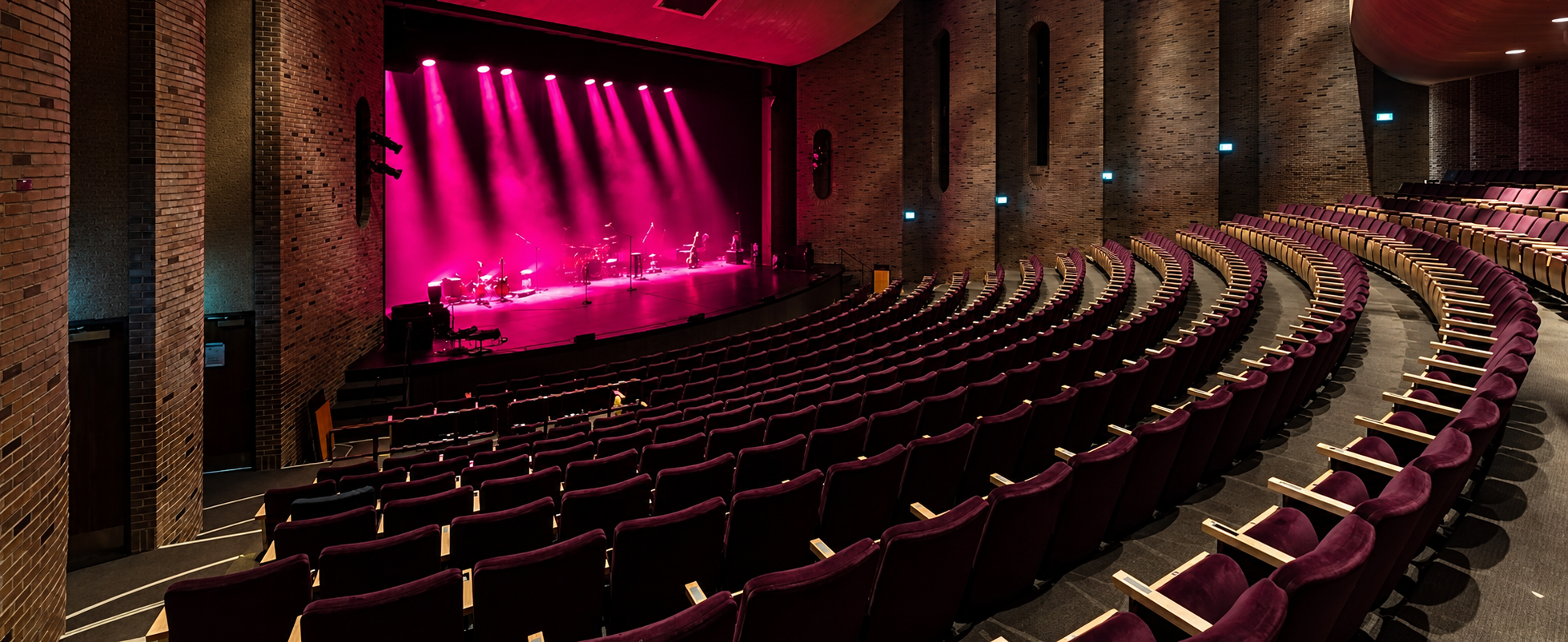 The Arden Theatre auditorium illuminated in magenta stage light