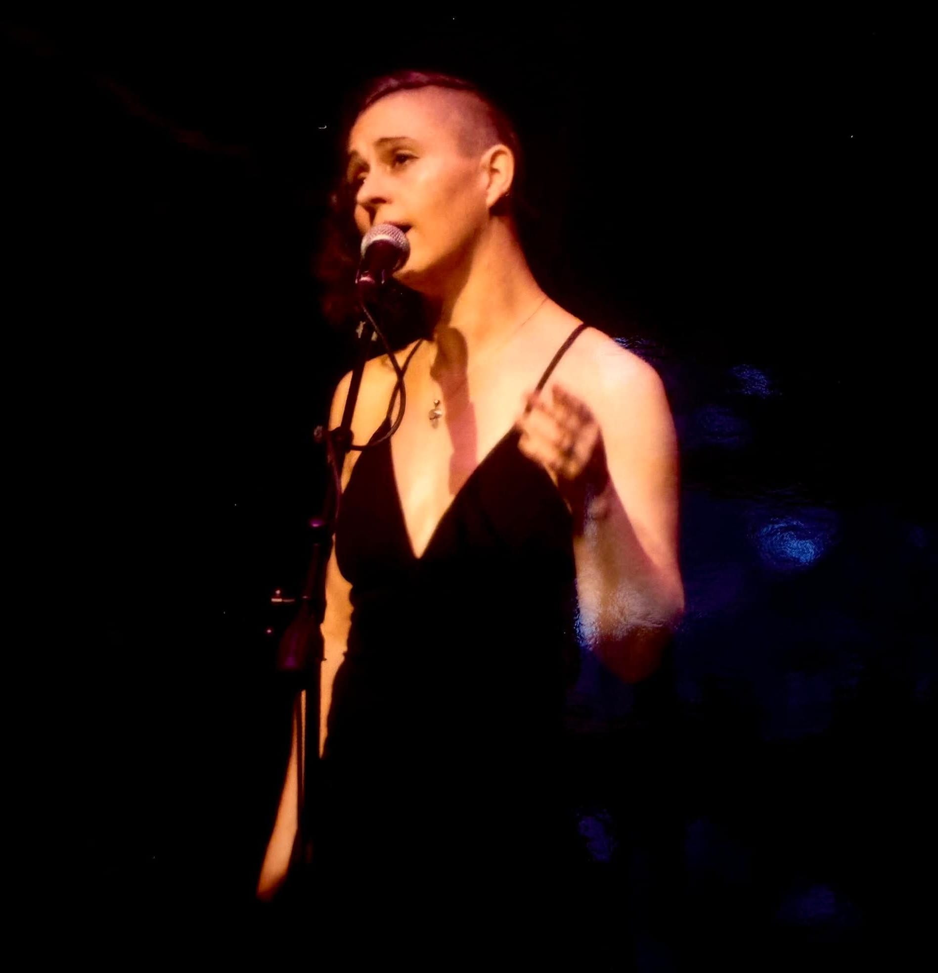 Laurelle K singing during a live performance